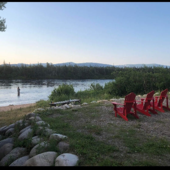 red chairs overlooking a river